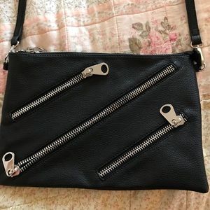 Faux leather side bag with zipper design .